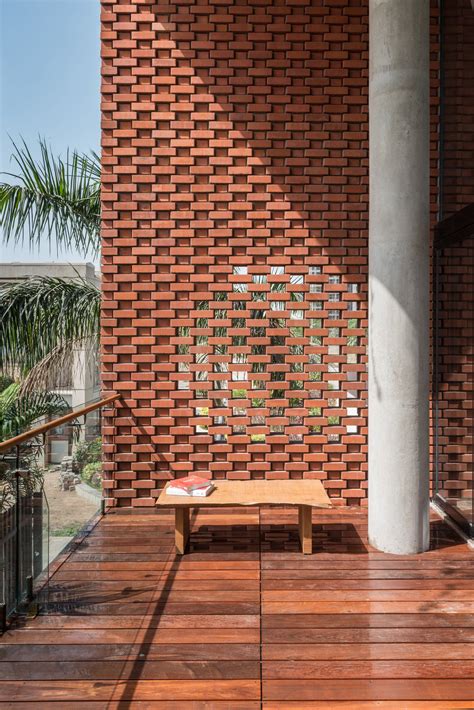 Rippling red brick facade shades house in Surat by Design Work Group | Brick exterior house ...