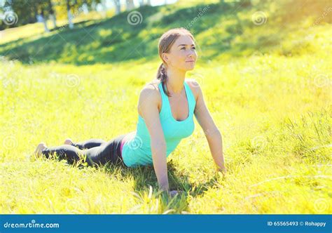 Young Woman Doing Yoga Exercises on Grass in Summer Stock Image - Image of position, park: 65565493