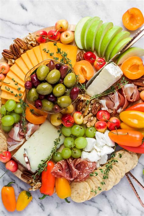 how to make a cheese platter round cheese platter on a marble board with apples and apricots