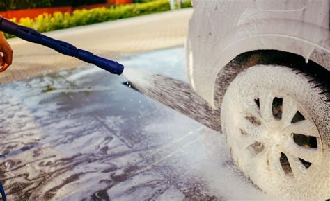 Premium Photo | Foaming the car with the foam car wash man washing car on the self washing ...