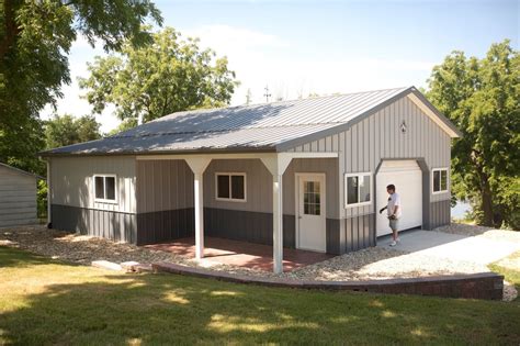 a man standing in front of a garage next to a yard with trees and grass