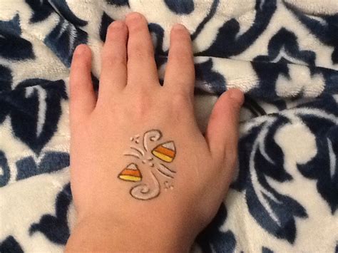 Candy corn face paintings!🎃 | Print tattoos, Face painting, Paw print