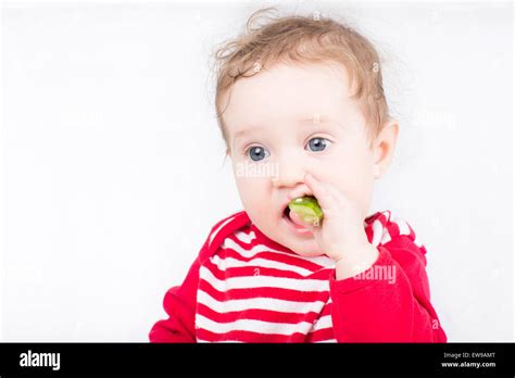 Funny baby eating a cucumber Stock Photo - Alamy