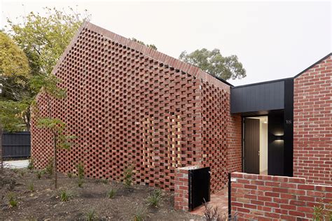 Recycled brick screens wrapping these two dwellings help thermal ...