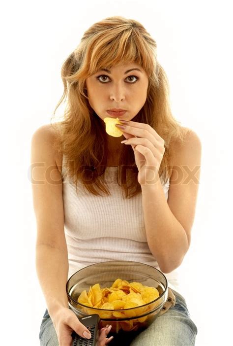 Lovely girl eating potato chips | Stock Photo | Colourbox