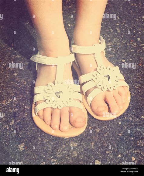 Little girl's feet in sandals Stock Photo, Royalty Free Image: 310159984 - Alamy