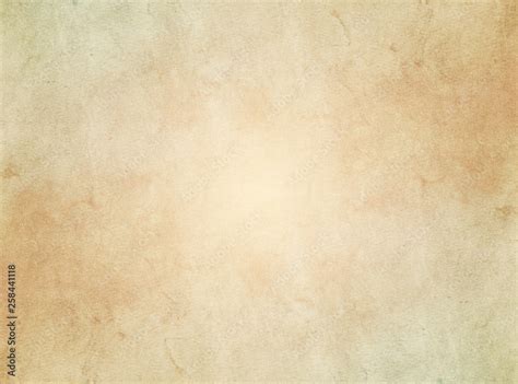 An elegant, beige, tan, grunge parchment texture background with ...