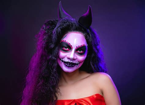 Premium AI Image | young woman with gothic vampire makeup on Halloween party over black background