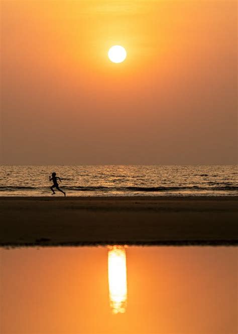 Silhouette of Person Running on the Beach during Sunset · Free Stock Photo