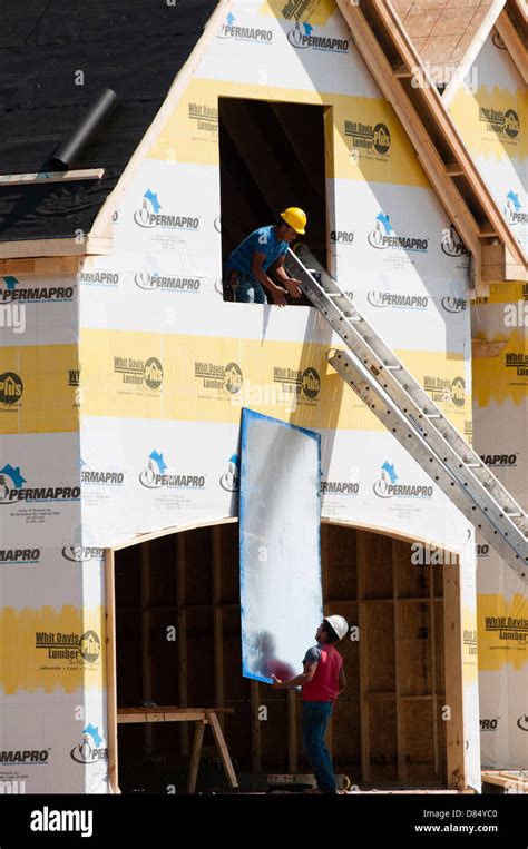 Construction workers on residential home construction site Stock Photo - Alamy