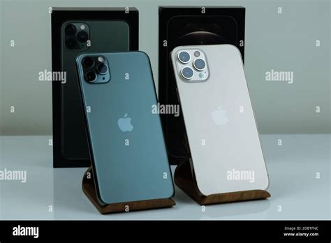 iPhone 12 Pro Max in Gold next to iPhone 11 Pro Max in Midnight Green color Stock Photo - Alamy