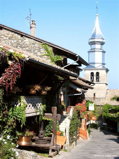 Yvoire, France - The church tower seen from an old street in Yvoire.