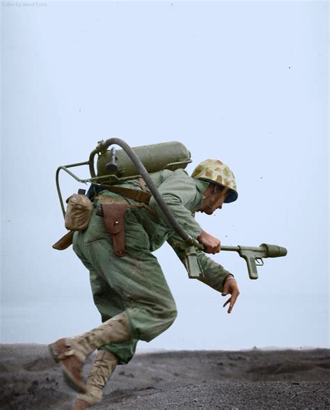 A Marine flamethrower operator moves forward to assault a Japanese pillbox on Motoyama Airfield ...