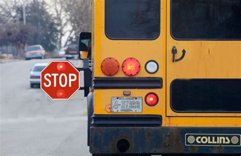 School bus with flashing red lights and extended stop arm - Free DMV Test