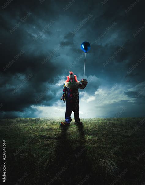 Scary clown on a dark background Stock Photo | Adobe Stock