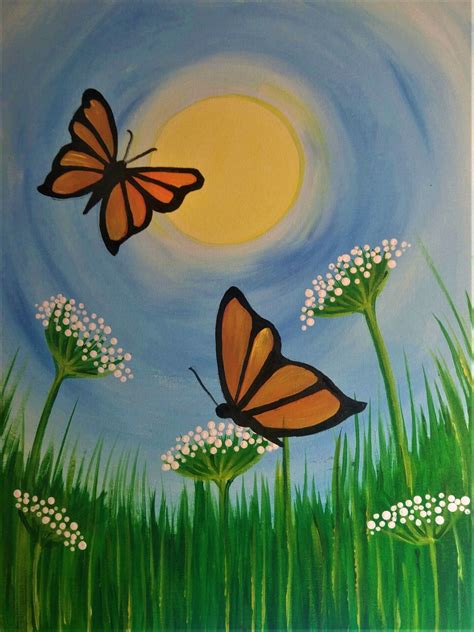 two butterflies are flying in the sky above some white flowers and green grass on a sunny day