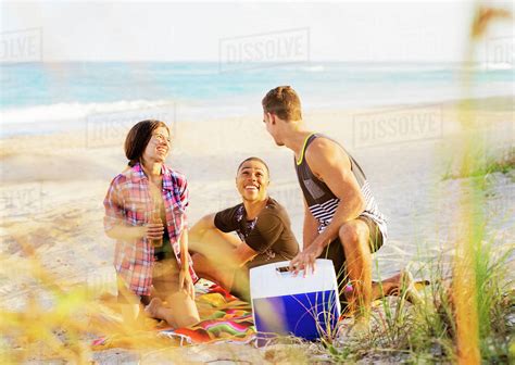 Young people relaxing on beach - Stock Photo - Dissolve