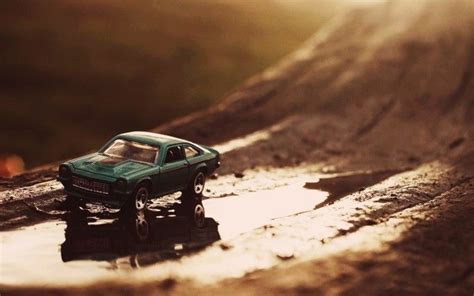 a toy car sitting on top of a puddle