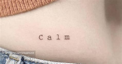 Tattoo of the word "calm" located on the lower back.