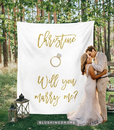 a bride and groom kissing in front of a wedding banner with the words christmas will you marry me?