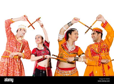 4 indian Rajasthani and Gujrati couple Navaratri Dandiya dance Stock ...