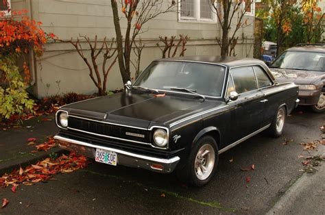 OLD PARKED CARS.: 1967 Rambler American Rogue Hardtop.