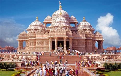 a group of people standing in front of a large building with many pillars and domes