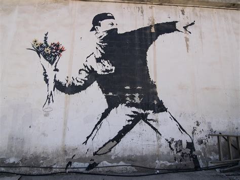 The Meaning Behind Banksy's 'Rage, the Flower Thrower'