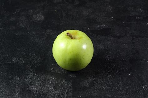 Premium Photo | Green apple healthy fruit on black background