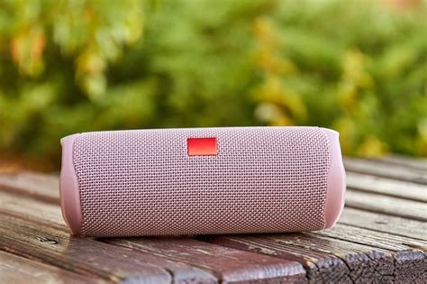 Premium Photo | Portable pink wireless speaker in the city