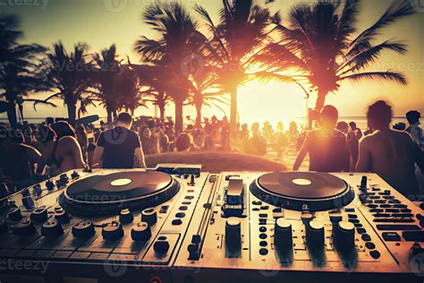 Dj mixing outdoor at beach party festival with crowd of people in background - Summer nightlife ...