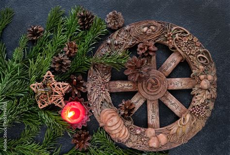 wiccan altar with Wheel of the year candle, amulet deer, cones, fir ...