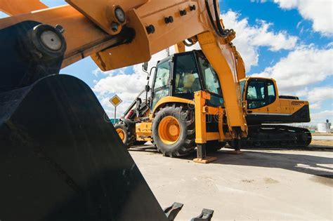 Road-building Machinery, Tractors Yellow Excavators in Open Air in Working Position Stock Photo ...