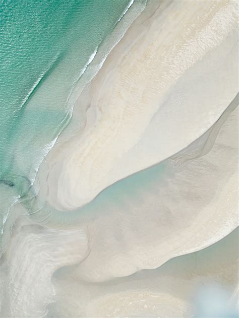 An aerial view of a sandy beach and ocean photo – Free Nature Image on Unsplash