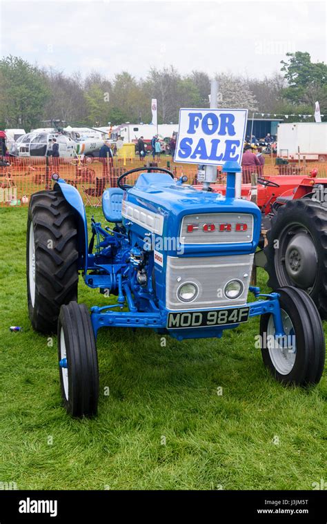 Classic Ford blue 1967 tractor with a For Sale sign Stock Photo - Alamy