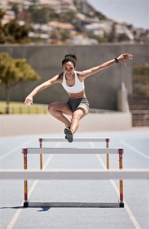 Premium Photo | Fitness training and woman jumping hurdles for sports ...