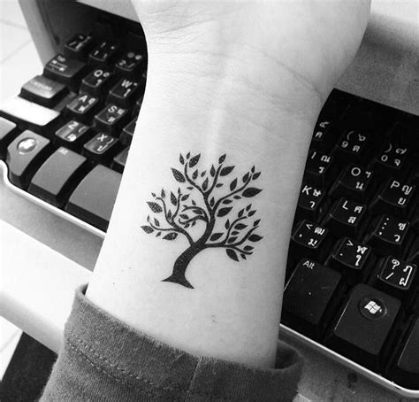 Tree Tattoos: Nature-Inspired Body Art | Art and Design | Tree tattoo small, Wrist tattoos ...