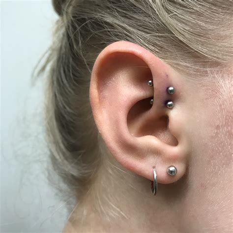 a woman with two piercings on her ear