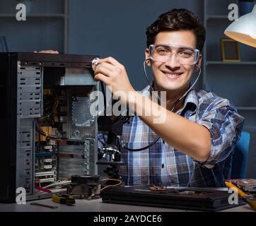 Computer repair concept with man inspecting with stethoscope Stock Photo - Alamy