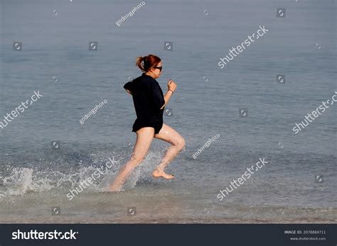 Sport Woman Running Barefoot On Beach Stock Photo 2078884711 | Shutterstock