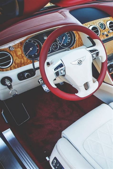 the interior of a classic car with wood trim and gauges