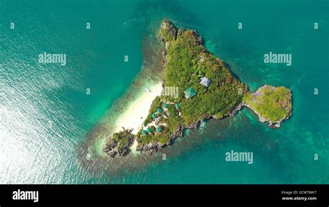 Beautiful beach on a tropical island with tourists, aerial view. Lopez Island, Hundred Islands ...