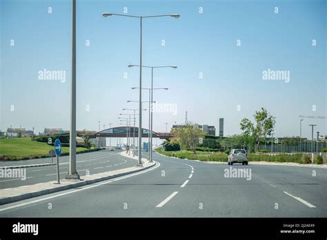 Corniche road to Doha city center from Airport. Doha Skyline in early ...