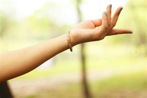 Close-Up Photography of Girl's Left Hand Wearing Bracelet · Free Stock Photo