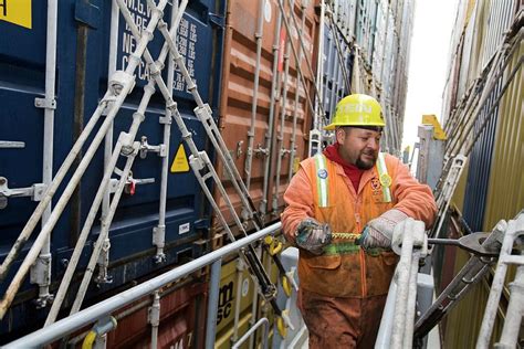 Port Worker Handling Cargo Containers Photograph by Jim West - Pixels