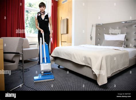 Hotel, room service, house keeping at work in a hotel room. Cleaning up, making the beds Stock ...