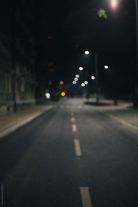 "Empty Street During The Night. Blurry." by Stocksy Contributor "Mak" - Stocksy