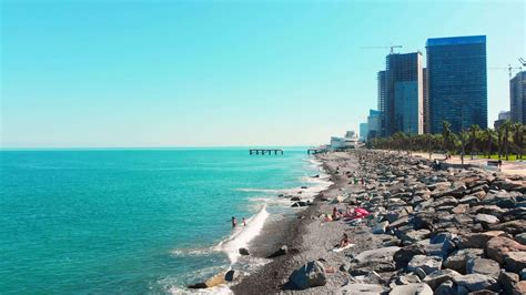 Batumi , Georgia, 2022 - Aerial top down fly over tourist at Sarpi Beach in Batumi enjoying ...