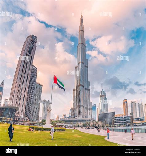 18 January 2023, Dubai, UAE: People walking by the promenade naer Arab Emirates flag and scenic ...