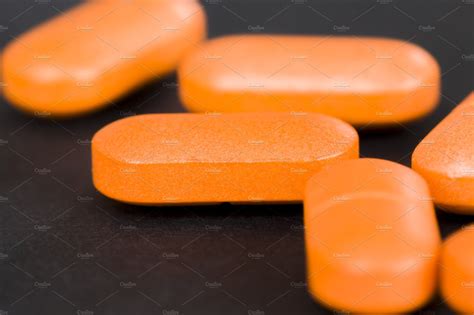 a long orange pill | Health & Medical Stock Photos ~ Creative Market